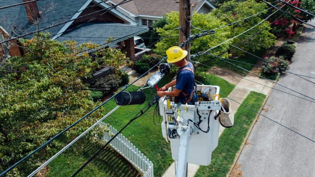 An electrical engineer repairing faulty electrical wires using safety tools and equipment