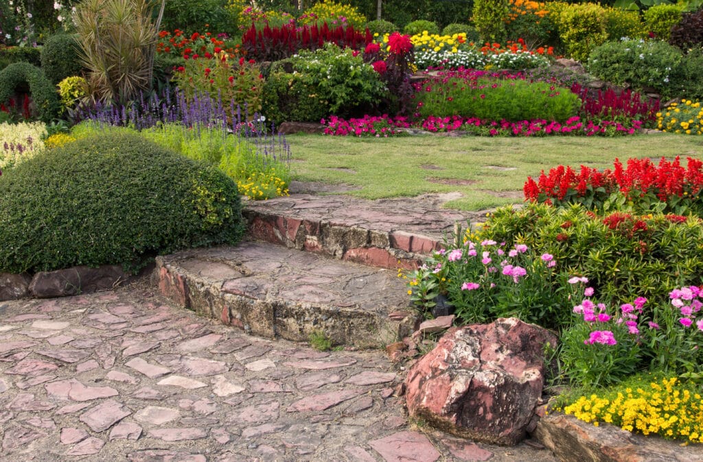 Home landscaping Kenya with stone path, seating, and native plants