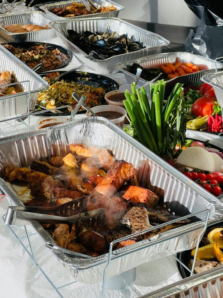 A buffet spread featuring grilled meats, seafood, vegetables, and salads at a Kenyan event, showcasing a blend of traditional and modern catering menu ideas.