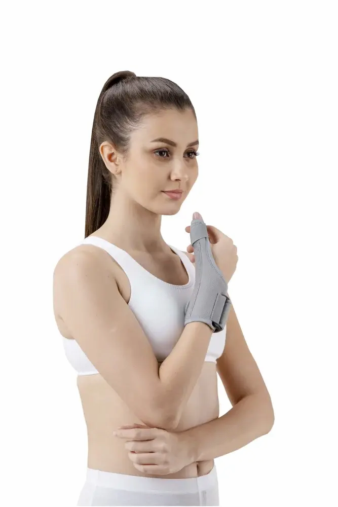 Person wearing gray wrist and thumb brace on right hand for orthopedic support Nairobideals Kenya